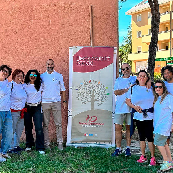 Volunteers next to a banner about social responsibility