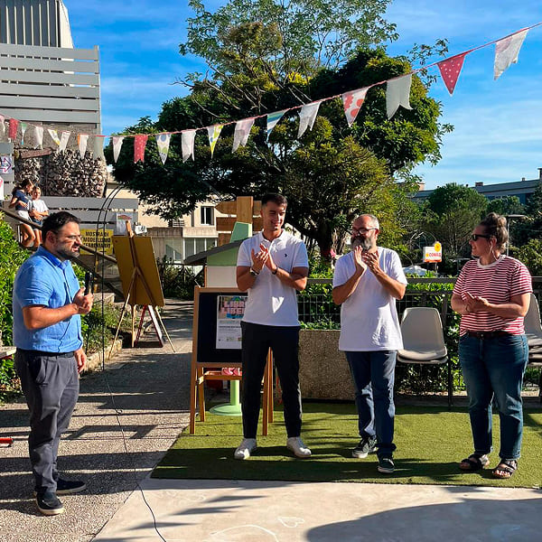 Four volunteers standing during an outdoor community event