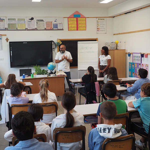 A volunteer conducting a classroom lesson with a group of students