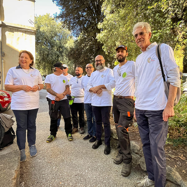 Group of volunteers posing and smiling in an urban area
