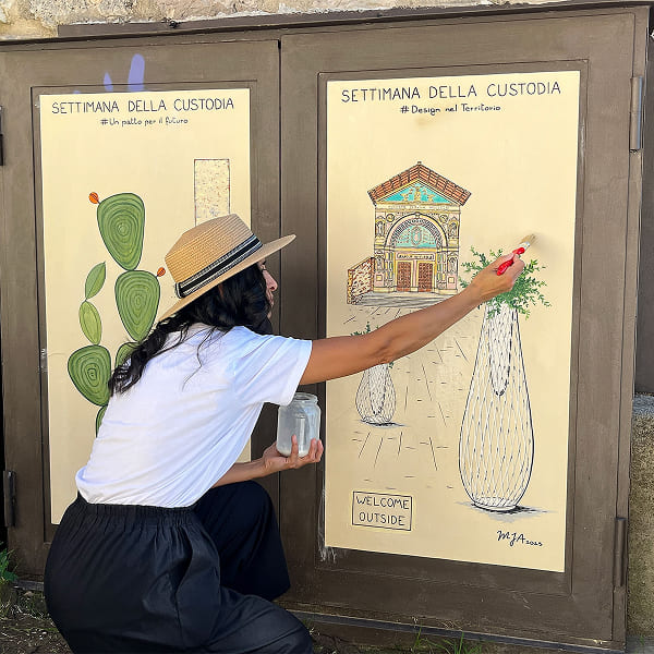 Artist painting mural on pane