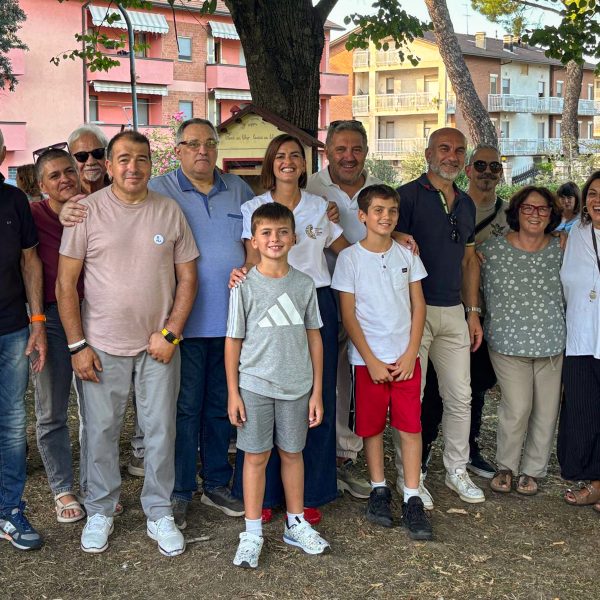 Group of adult and child volunteers together outdoors