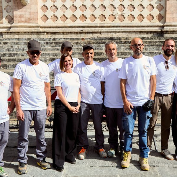 Group of volunteers in front of a historic building