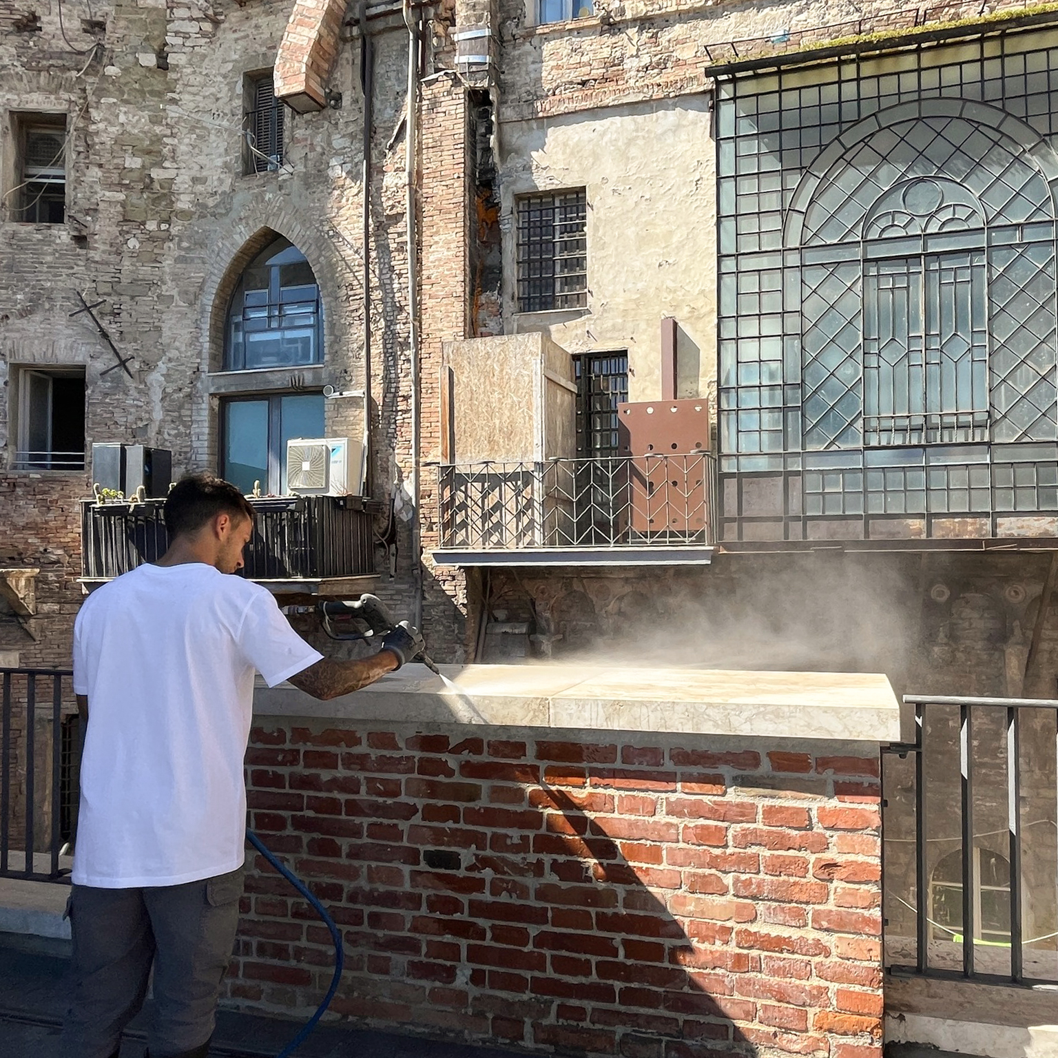 Man cleaning a railing with a pressure washer