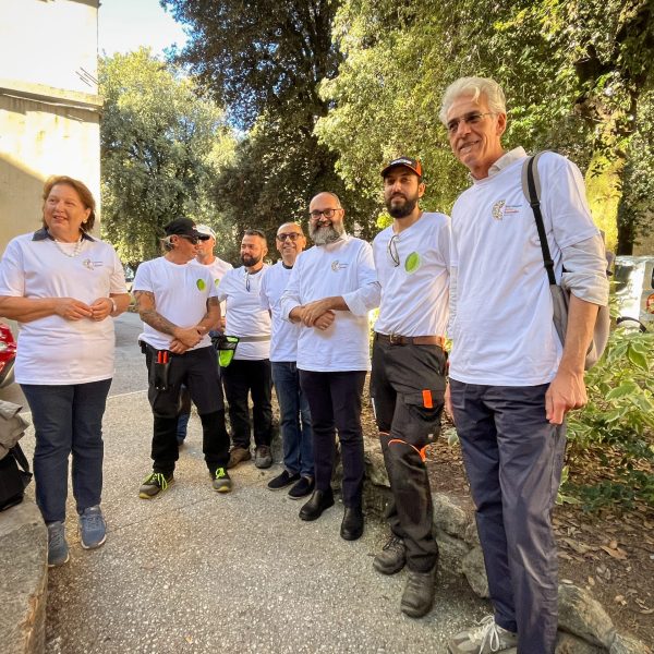 Group of volunteers posing and smiling in an urban area
