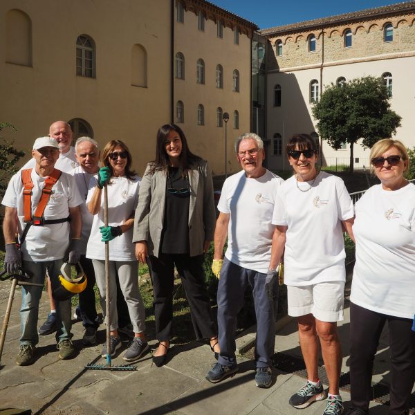 Volunteers with tools in front of a historic building