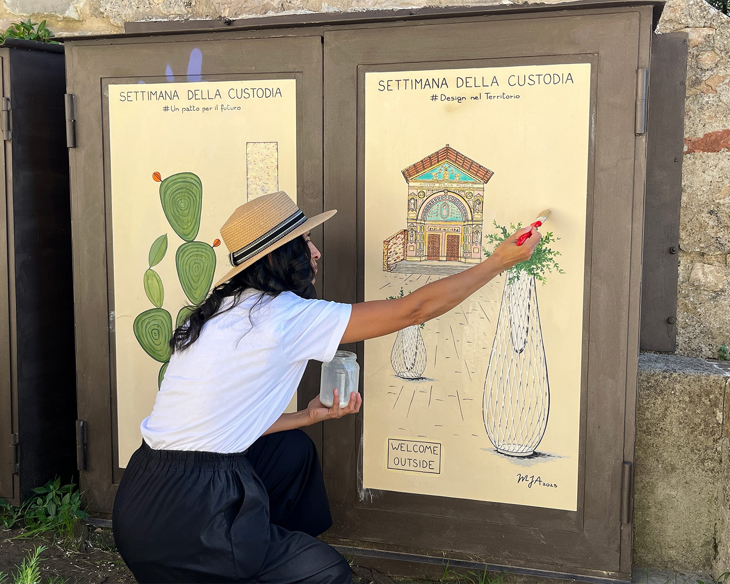 Artist painting mural on pane